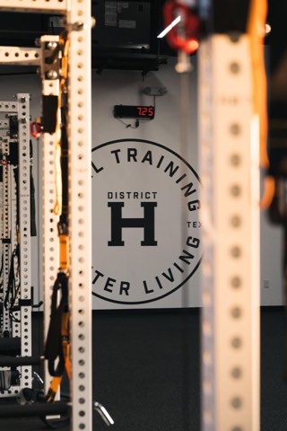 Demo story photo: the District H gym interior with the wing logo on the wall